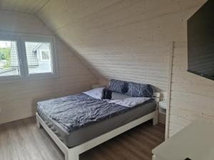 a small bedroom with a bed in a attic at San Escobar Dziwnówek in Dziwnówek +63 photos