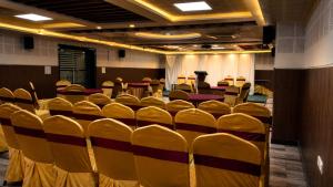 a conference room with chairs and a podium in it at Hotel SVA in Visakhapatnam