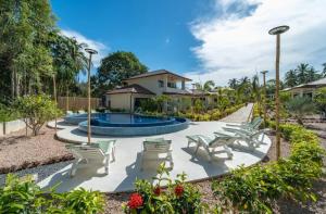 a resort with a swimming pool and lounge chairs at Villa Coco Escape in Ko Phangan
