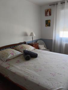 a bedroom with a large bed with pink flowers on it at L'agapanthe in Plouézec