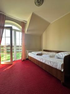 a bedroom with a bed and a large window at Viktorjan in Raszowa