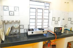 a kitchen with a counter with acomputer on it at Hotel Relax in Jaipur