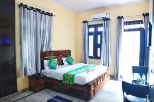a bedroom with a large bed and a window at Hotel Relax in Jaipur +60 photos