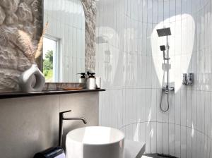 a bathroom with a sink and a shower at Zatura Dome Glamping in Panjadakan +6 photos