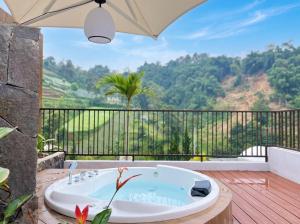 a bath tub sitting on top of a wooden deck at Zatura Dome Glamping in Panjadakan