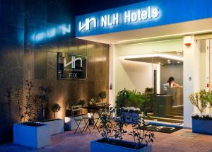 a woman is standing outside of a nilil hotel at NLH FIX | Neighborhood Lifestyle Hotels in Athens