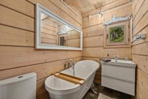 a bathroom with a toilet and a sink and a mirror at Przystanek Zielnik in Łosie +31 photos