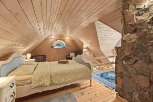 a bedroom with a bed and a stone wall at Przystanek Zielnik in Łosie