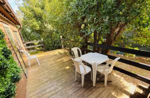 a table and chairs sitting on a wooden deck at La cabane Proche circuit in Le Castellet