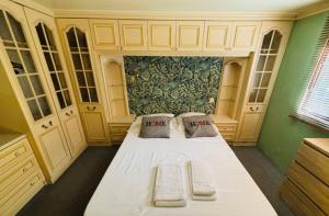 a bedroom with a large white bed with two pillows at La cabane Proche circuit in Le Castellet