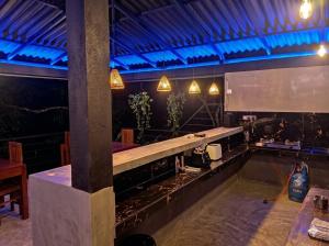 a room with a bar with a table in it at FlyOn Resort in Dickwella