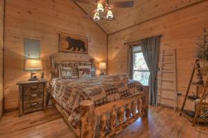 a bedroom with a bed in a log cabin at Squirrels Hideaway Fire Pit MTN Views in Copperhill