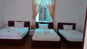 Postel nebo postele na pokoji v ubytování Mango Garden Hoi An Homestay