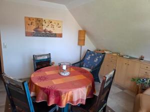 a dining room with a table and chairs at Appartement auf dem Land in Neuenkirchen +5 photos