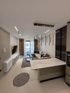 a living room with a couch and a table at Sunrise Home Getaway - Shëngjin in Shëngjin