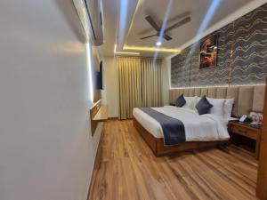 a bedroom with a bed and a ceiling fan at Platinum Arc in Jaipur