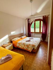a bedroom with two beds and a window at Villa Gaia in Bordighera