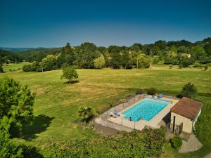an overhead view of a swimming pool in a field at La Ferme de la Croix d'Allon in Sarlat-la-Canéda