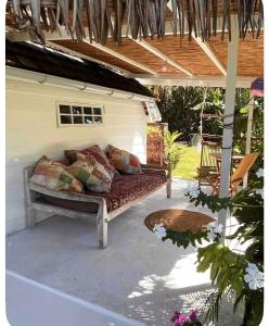 a couch sitting on a patio under a pergola at Atunumai in Temae