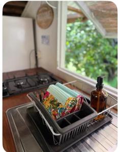 a kitchen sink with a dish rack with food in it at Atunumai in Temae