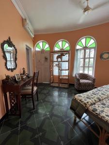 a room with a table and chairs and windows at Villa Rivercat in Mandrem
