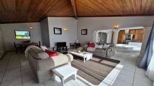a living room with two couches and a table at Eagles Nest in Sedgefield
