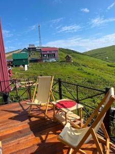 two chairs sitting on top of a wooden deck at Cloudtop House - Gomismta in Gomi