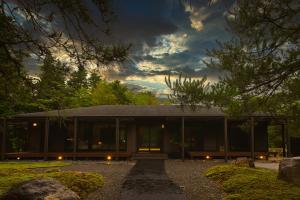 a house with glass doors in a yard at Hakone Kairai in Hakone