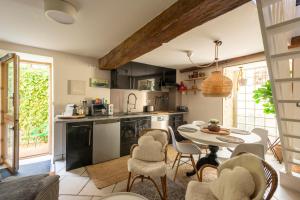 a kitchen and dining room with a table and chairs at La petite maison CARRÉ in Talant