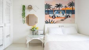 a bedroom with a bed and a table with flowers at Taean Tteulapbada Pension in Taean