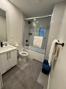 a bathroom with a shower and a toilet and a sink at Hope Sunshine Valley Scenic Mountain View House 3BR 3Bath in Hope