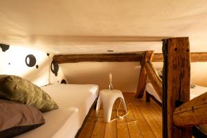 a bedroom with a bed and a table in a room at La petite maison CARRÉ in Talant +7 photos