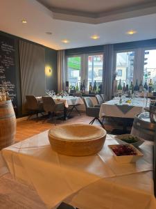 a restaurant with tables and chairs and a table with a bowl on it at Schäfers Hotel in Cloppenburg