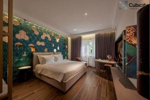 a hotel room with a bed and a desk at Cubicity Hoang Dieu in Ho Chi Minh City