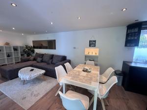 a living room with a table and a couch at Juicy Private Apartments with Jacuzzi in Szentendre