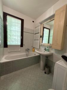 a bathroom with a bath tub and a sink at residenza gelsomino - relax and view in Bellano