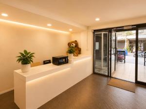 a lobby with a counter with a tv and a teddy bear at Happy Room 3 in Pattaya South