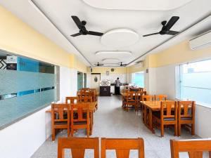 a dining room with wooden tables and chairs at Hotel The Four Square in Digha