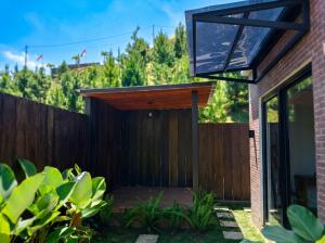 a wooden entrance to a house with a fence at Villa Kahuripan Triangle in Bandung