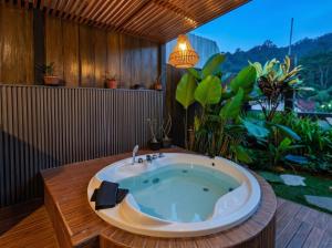 a jacuzzi tub in a room with a garden at Villa Kahuripan Triangle in Bandung