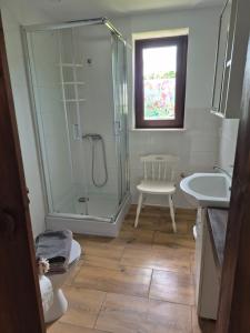 a bathroom with a shower and a sink at Chatki u Patki in Łebieniec