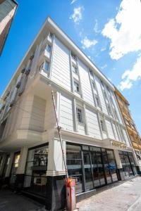a large white building with a crane in front of it at Business Life Hotel & SPA Bakırköy in Istanbul