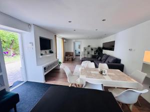 a living room with a table and a couch at Juicy Private Apartments with Jacuzzi in Szentendre