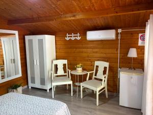 a bedroom with a bed and a table and chairs at Camping Torremolinos in Torremolinos