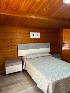 a bedroom with a bed in a wooden cabin at Camping Torremolinos in Torremolinos