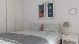 a bedroom with a bed and a picture on the wall at La Casita House in St Francis Bay +13 photos