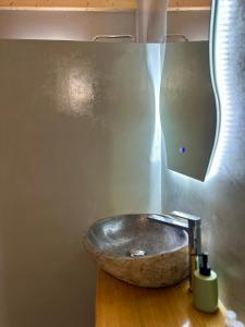a bathroom with a stone sink with a waterfall at Olive Haven in Provatas +23 photos