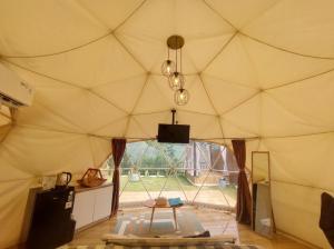 a room with a large tent with a window at Maple Dome Glamping in Bandung
