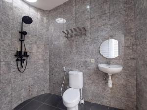 a bathroom with a toilet and a sink at Maple Dome Glamping in Bandung