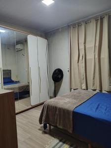 a bedroom with a bed and a mirror at Sítio Casa Verde in Uruguaiana